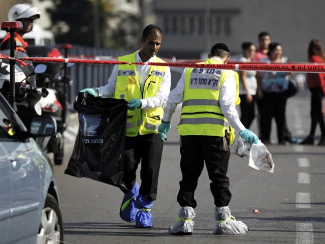 Members of the Israeli Zaka emergency response team at the scene of a stabbing in Tel Aviv